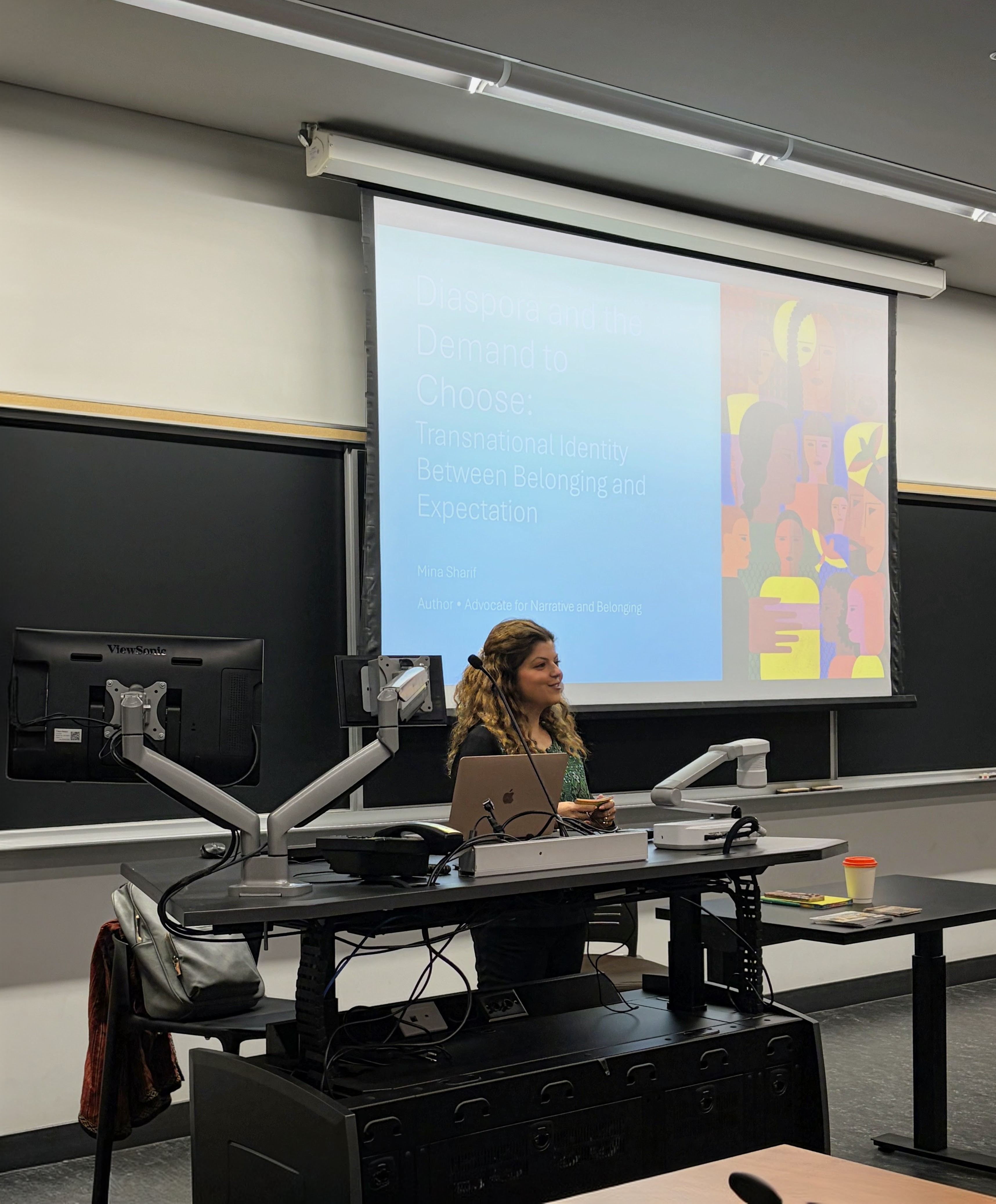 Mina Sharif delivering a keynote on diaspora identity at a university lecture